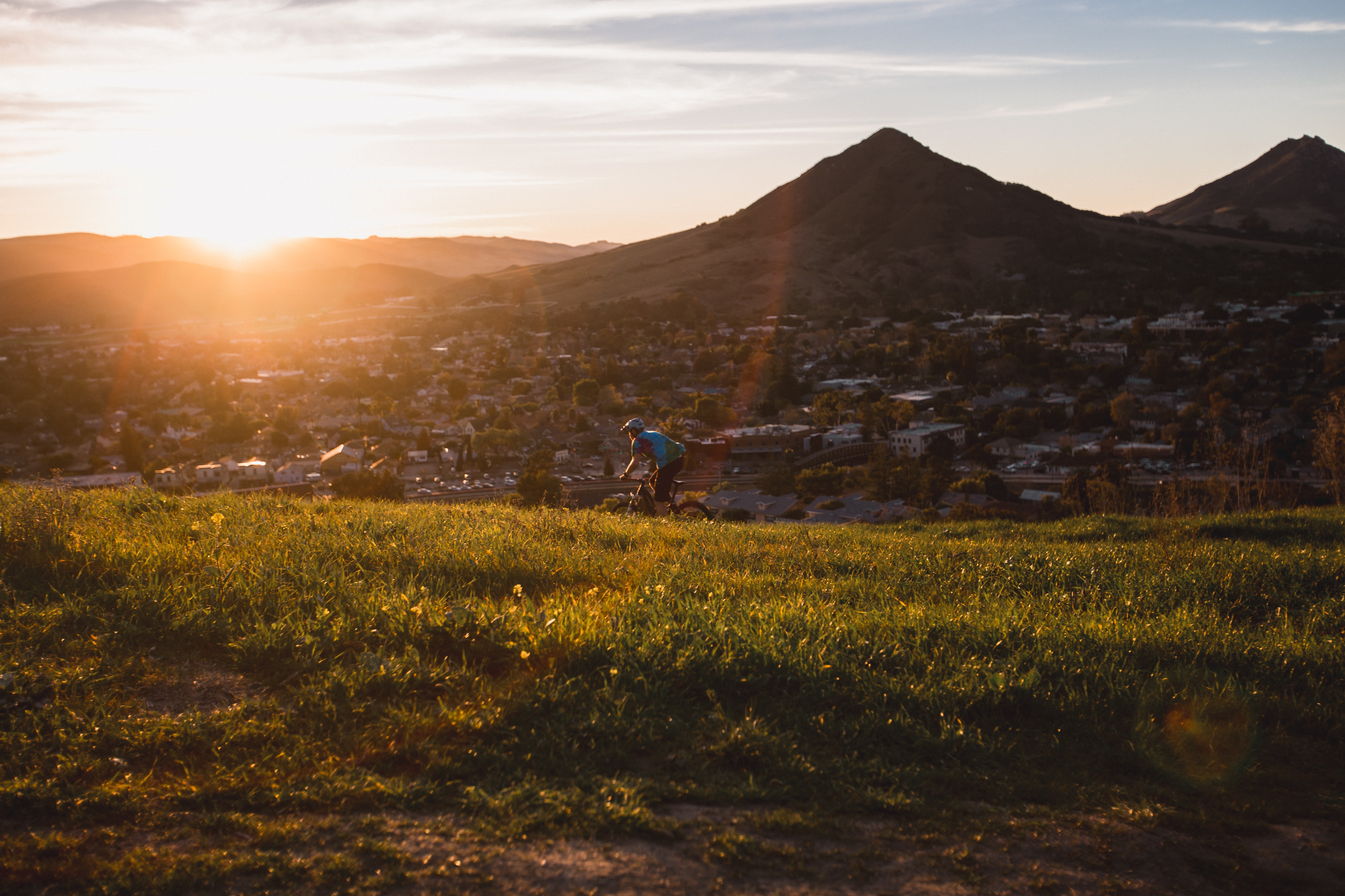 Image of green hill in San Luis Obispo at sunset.